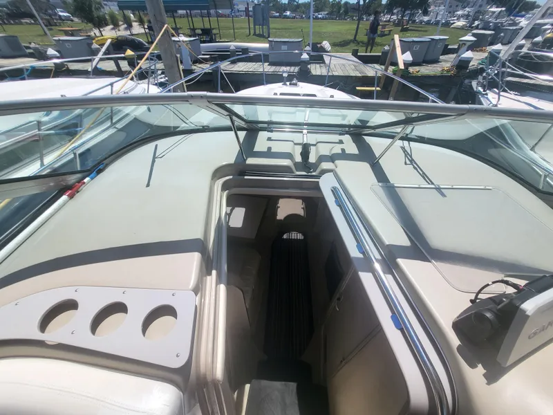 Slide: The Image of 1999 Sea Ray 290 Sundancer boat interior with open cabin and seating area. - 34