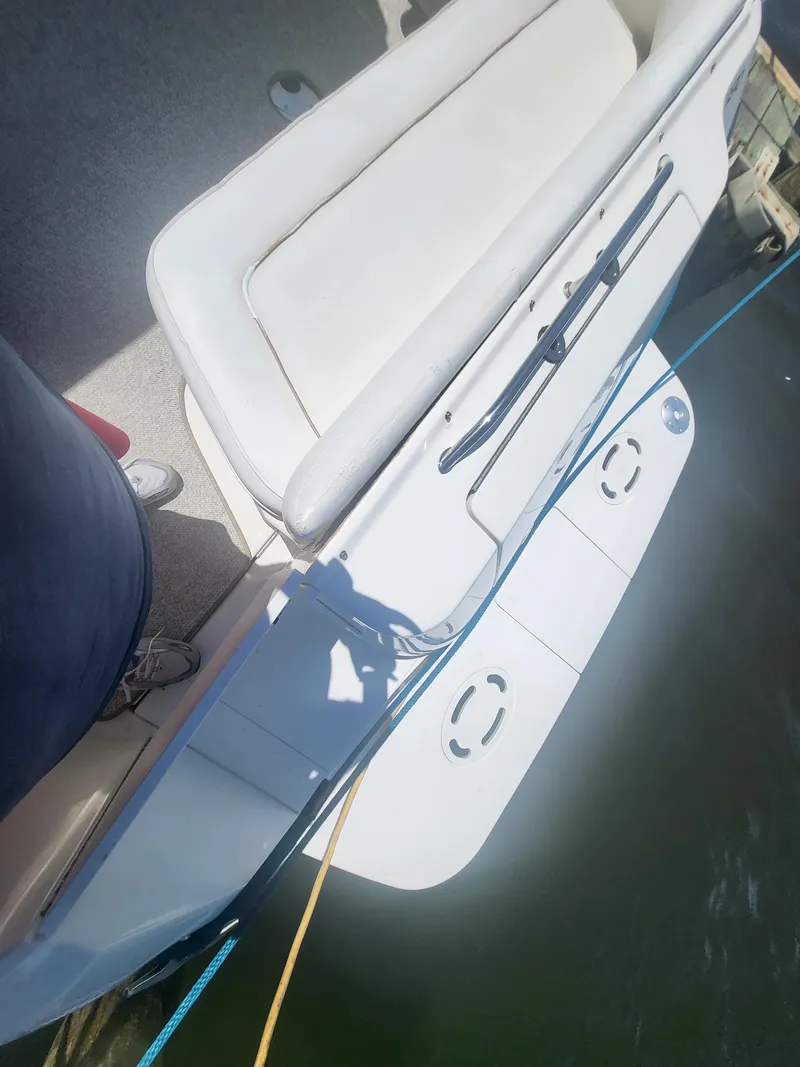 Slide: The Image of 1999 Sea Ray 290 Sundancer boat with white seating and swim platform. - 35