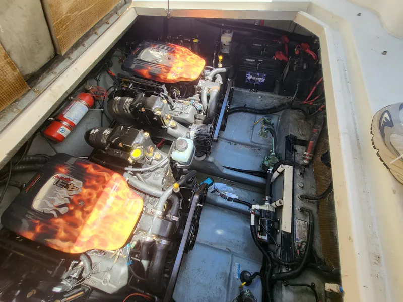 Slide: The Image of Engine compartment of a 1999 Sea Ray 290 Sundancer with dual engines and fire extinguisher. - 37