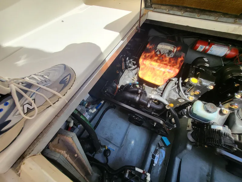 Slide: The Image of Engine compartment of a 1999 Sea Ray 290 Sundancer boat with visible components. - 38
