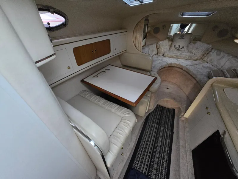 Slide: The Image of Interior of 1999 Sea Ray 290 Sundancer boat with seating and sleeping area. - 39