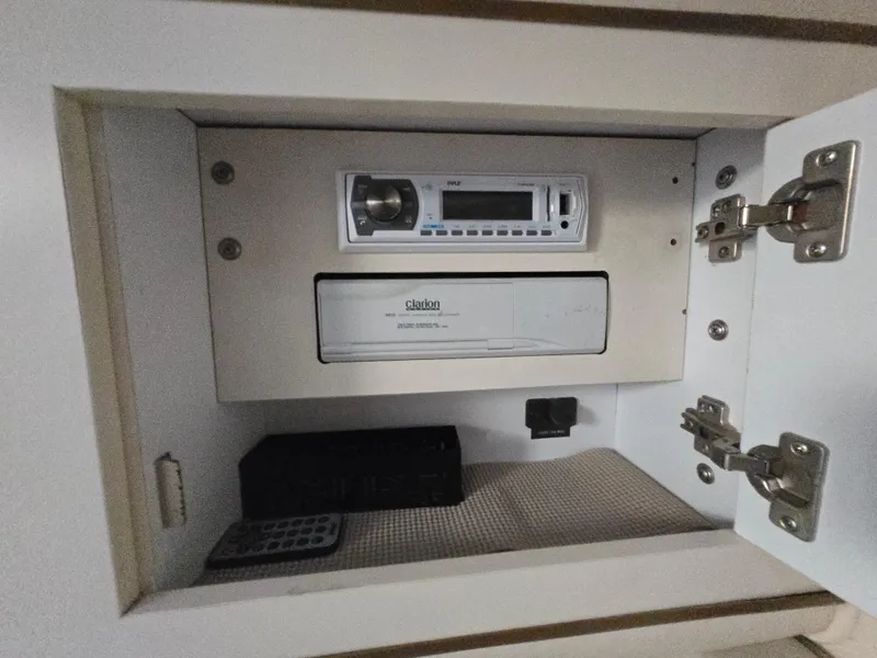 Slide: The Image of 1999 Sea Ray 290 Sundancer stereo system with Clarion components in a cabinet. - 46