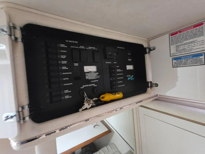 Slide: The Image of Electrical panel inside a 1999 Sea Ray 290 Sundancer boat cabin. - 47