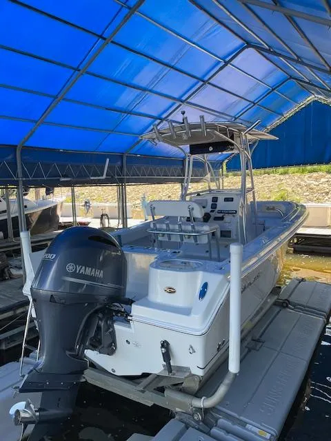 Slide: The Image of 2015 Sailfish 220 boat with Yamaha engine under blue canopy. - 1