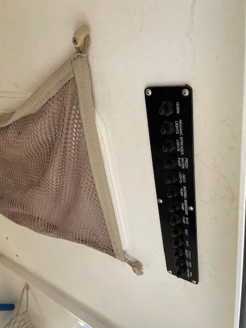 Slide: The Image of Control panel and storage net on a 2015 Sailfish 220 boat interior. - 19