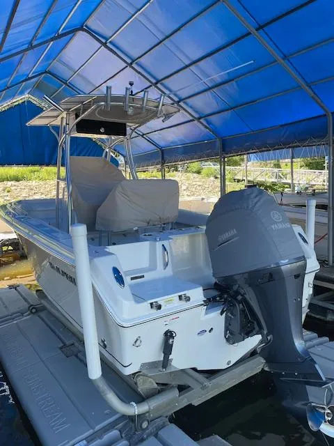 Slide: The Image of 2015 Sailfish 220 boat under blue canopy with Yamaha outboard motor. - 2