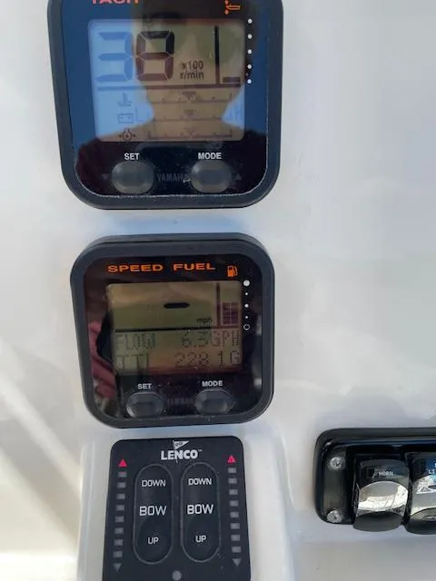 Slide: The Image of Close-up of 2015 Sailfish 220 boat dashboard with digital displays and controls. - 21