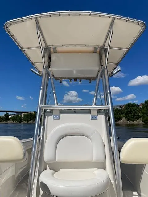 Slide: The Image of 2015 Sailfish 220 boat with T-top, on calm water under blue sky. - 6