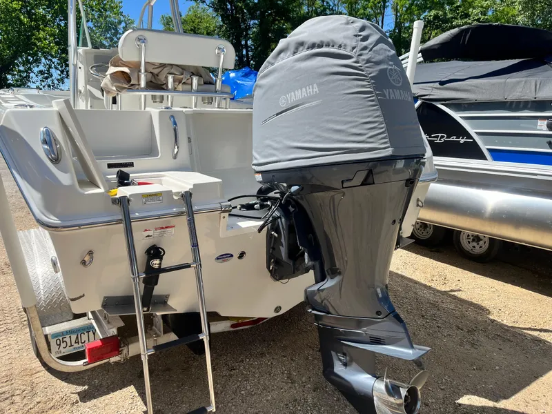 Slide: The Image of 2015 Sailfish 220 boat with Yamaha outboard motor, parked on a sunny day. - 9