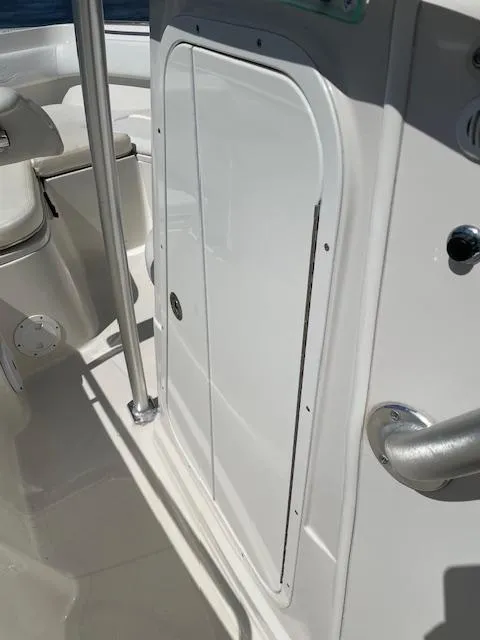 Slide: The Image of 2015 Sailfish 220 boat interior with storage compartment and seating area. - 20