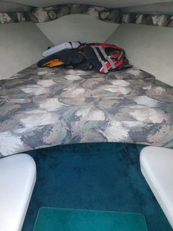 Slide: The Image of Interior cabin of a 1998 Baja 252I boat with camouflage-patterned bedding. - 4