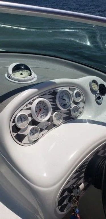 Slide: The Image of 1998 Baja 252I boat dashboard with gauges and compass. - 6