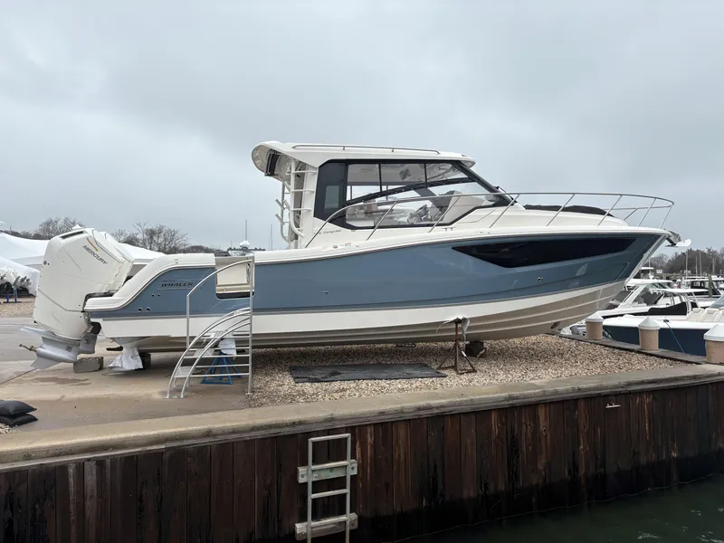 The Image of 2025 Boston Whaler 365 Conquest boat docked on a cloudy day. - 0