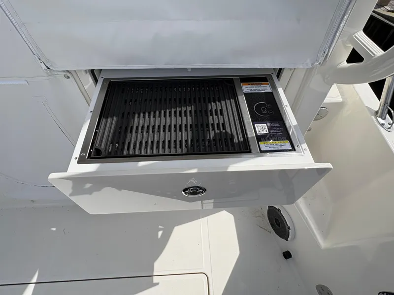 Slide: The Image of 2025 Boston Whaler 365 Conquest boat grill drawer, open and ready for use. - 10