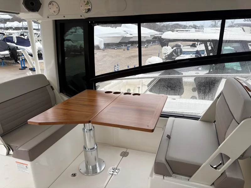 Slide: The Image of Interior of 2025 Boston Whaler 365 Conquest with seating and wooden table. - 17
