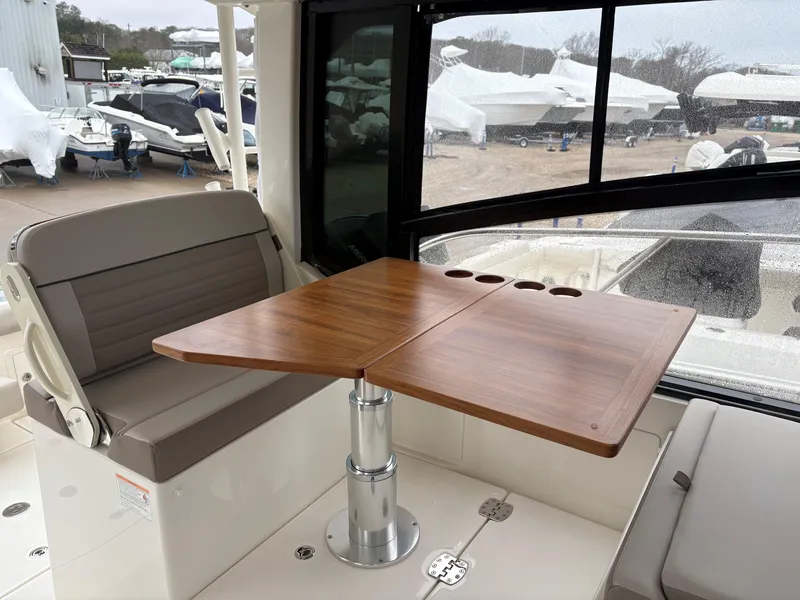 Slide: The Image of 2025 Boston Whaler 365 Conquest interior with wooden table and seating. - 18