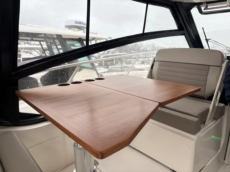 Slide: The Image of Interior of 2025 Boston Whaler 365 Conquest with wooden table and seating. - 19