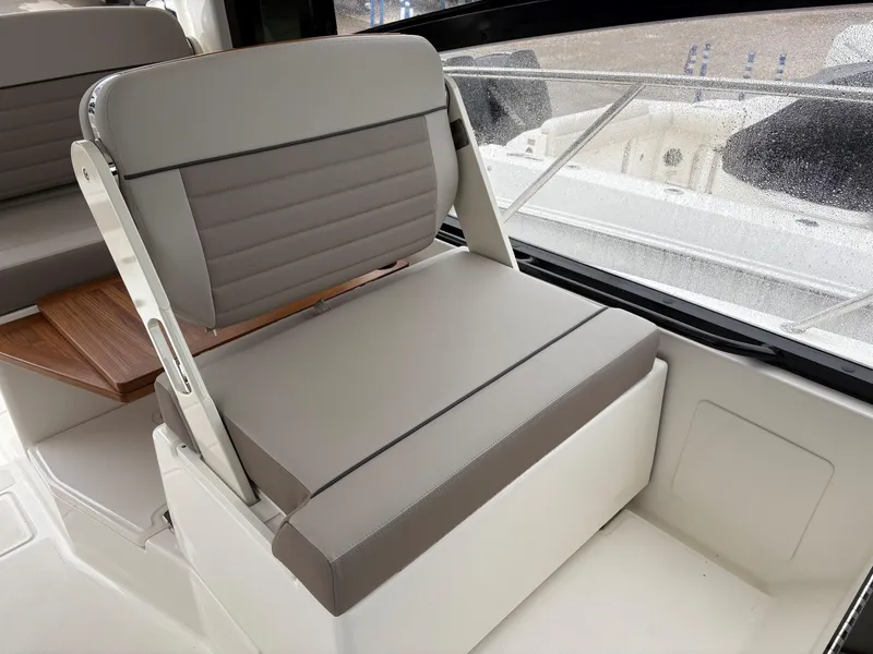 Slide: The Image of 2025 Boston Whaler 365 Conquest interior seating with gray upholstery and sleek design. - 21