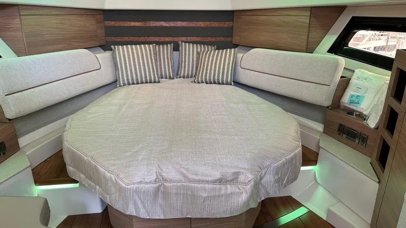 Slide: The Image of 2025 Boston Whaler 365 Conquest cabin interior with bed and cushions. - 26