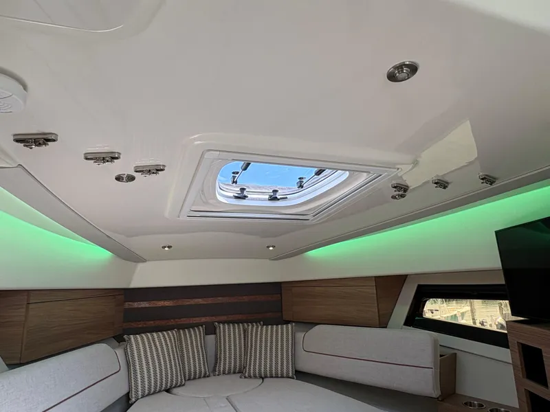 Slide: The Image of Interior of 2025 Boston Whaler 365 Conquest with skylight and modern seating. - 28