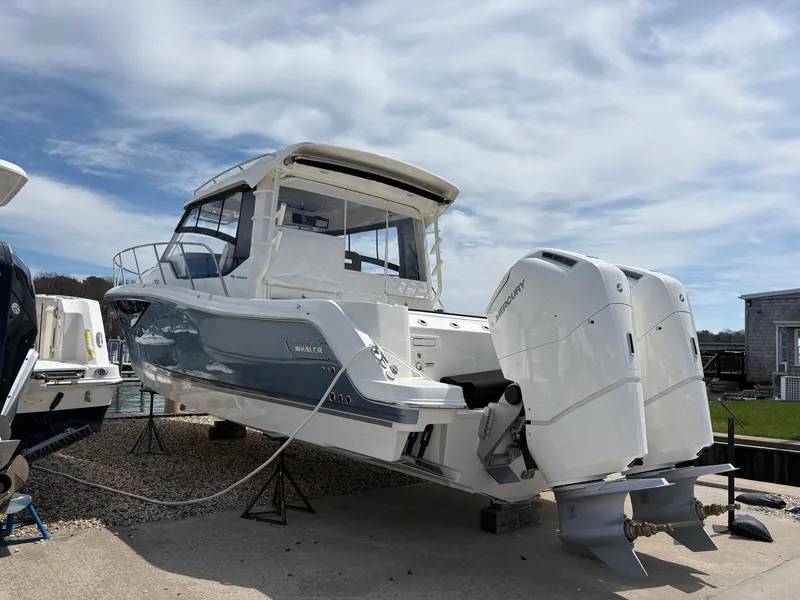 Slide: The Image of 2025 Boston Whaler 365 Conquest boat with dual outboard engines on display. - 3
