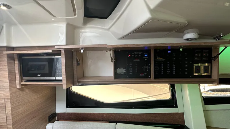 Slide: The Image of 2025 Boston Whaler 365 Conquest interior with microwave and control panel. - 32