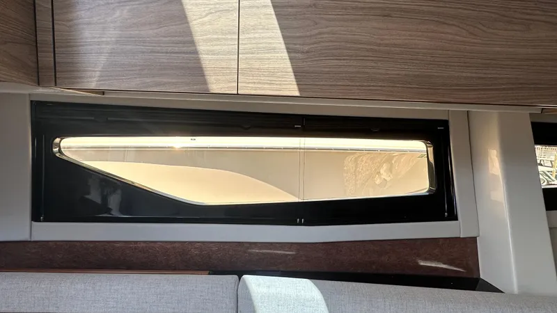 Slide: The Image of Interior view of 2025 Boston Whaler 365 Conquest, featuring sleek window design and modern cabinetry. - 33