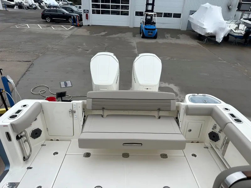 Slide: The Image of 2025 Boston Whaler 365 Conquest boat with dual engines and seating, docked at a marina. - 4
