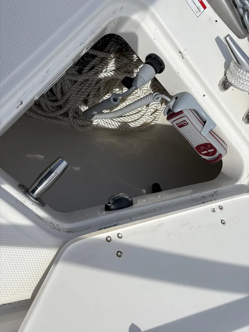 Slide: The Image of Storage compartment on 2025 Boston Whaler 365 Conquest with ropes and equipment. - 46