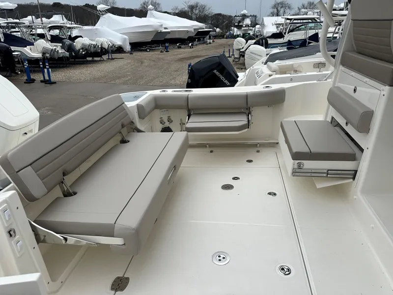 Slide: The Image of 2025 Boston Whaler 365 Conquest boat interior with cushioned seating and spacious deck. - 6