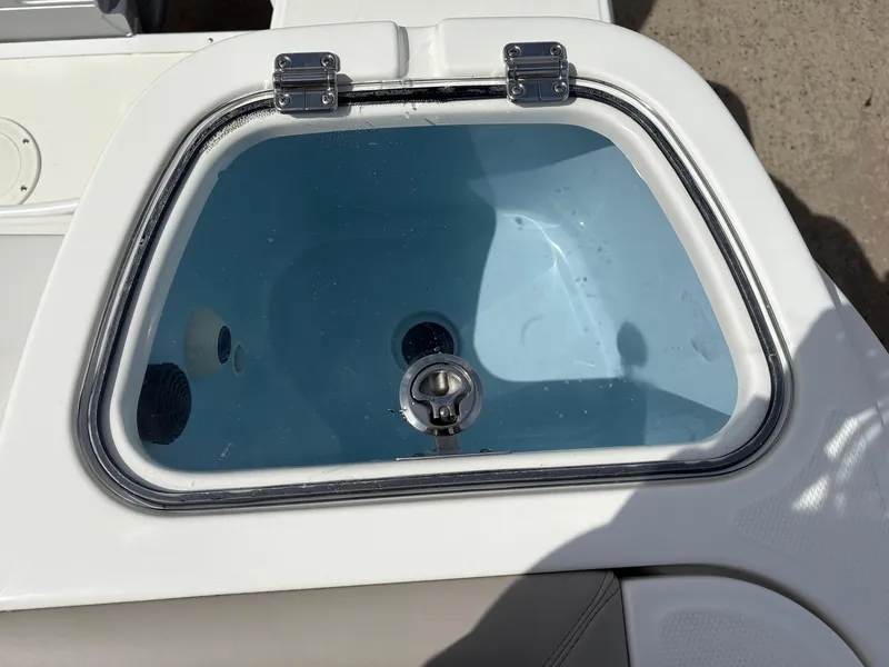 Slide: The Image of Livewell on 2025 Boston Whaler 365 Conquest boat, featuring a clear lid and stainless steel hardware. - 8