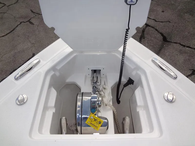 Slide: The Image of 2024 Fountain 32NX boat anchor compartment with winch and rope. - 11