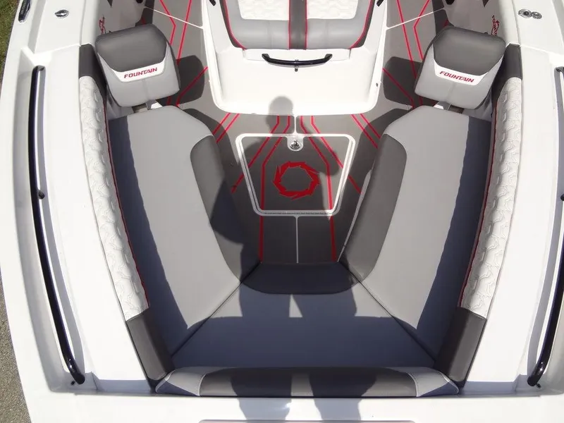 Slide: The Image of 2024 Fountain 32NX boat interior with gray and red seating. - 13