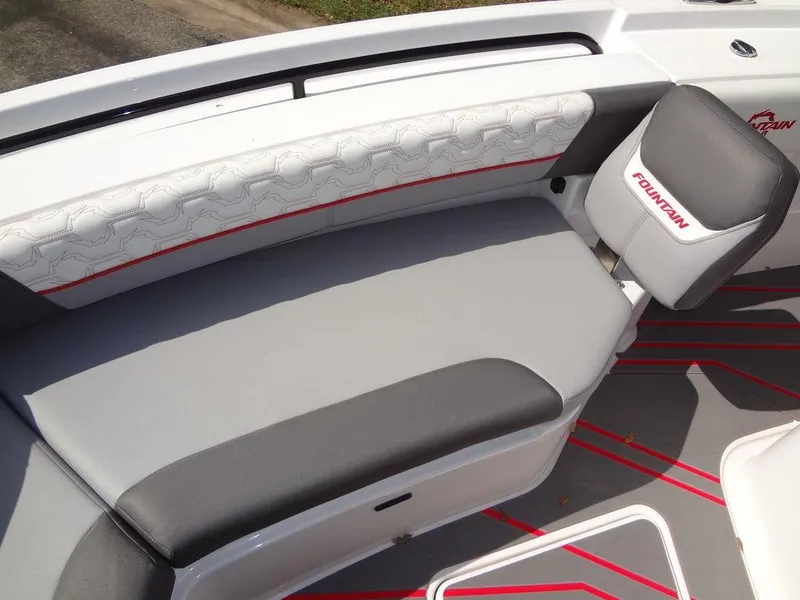 Slide: The Image of 2024 Fountain 32NX boat interior seating with gray and white upholstery. - 16