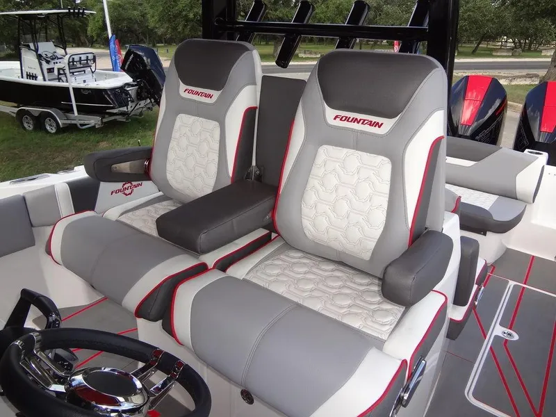 Slide: The Image of 2024 Fountain 32NX boat interior with dual captain's chairs and modern design. - 20
