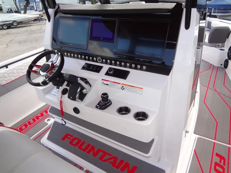 Slide: The Image of 2024 Fountain 32NX boat dashboard with advanced navigation screens and controls. - 23