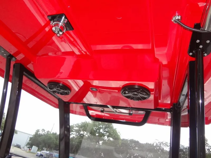 Slide: The Image of 2024 Fountain 32NX boat with red canopy and built-in speakers. - 24