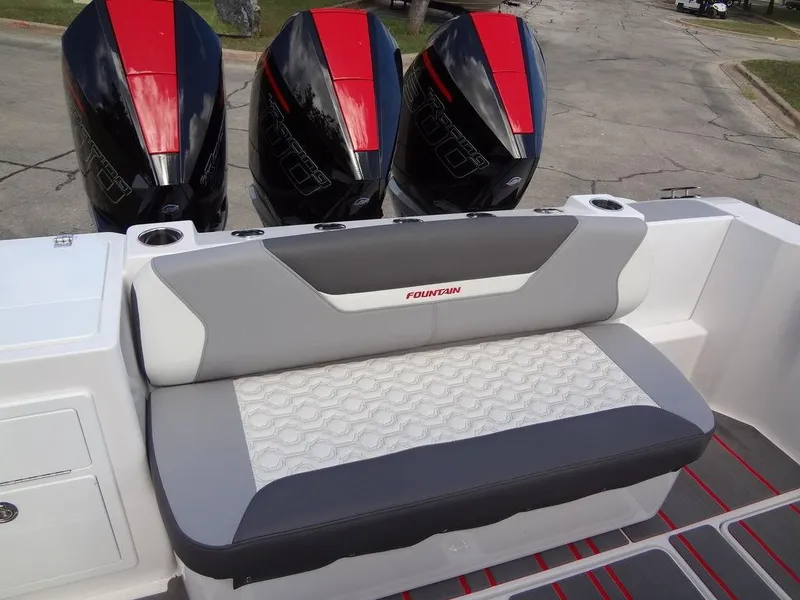 Slide: The Image of 2024 Fountain 32NX boat with triple outboard engines and cushioned seating. - 28