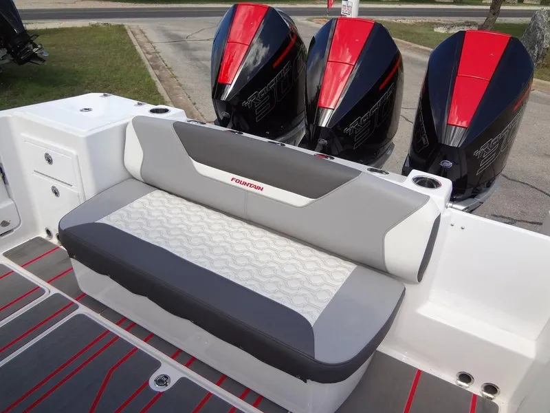Slide: The Image of 2024 Fountain 32NX boat with triple outboard engines and cushioned seating. - 29