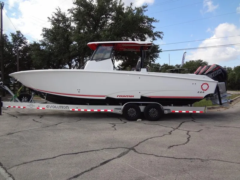 Slide: The Image of 2024 Fountain 32NX boat on a trailer, side view. - 3