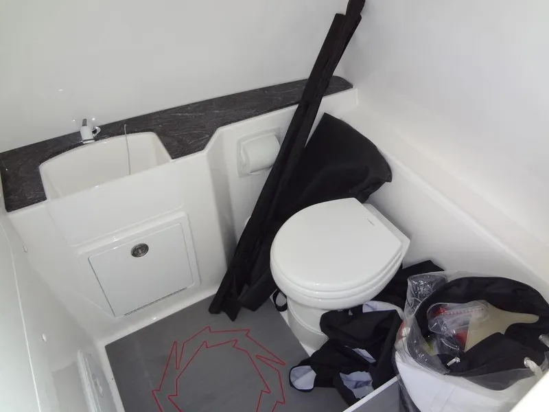 Slide: The Image of 2024 Fountain 32NX boat bathroom with sink and toilet. - 33