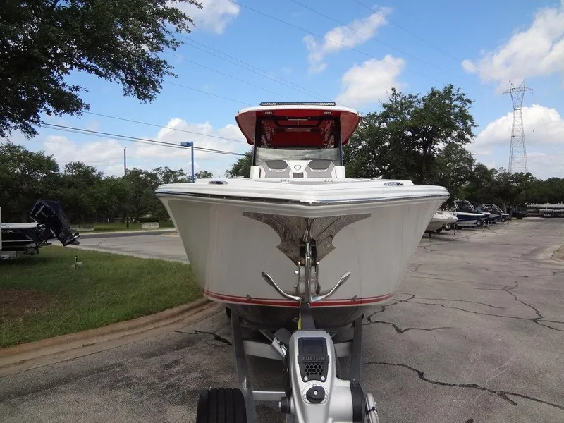 Slide: The Image of 2024 Fountain 32NX boat on trailer, front view, outdoors. - 4
