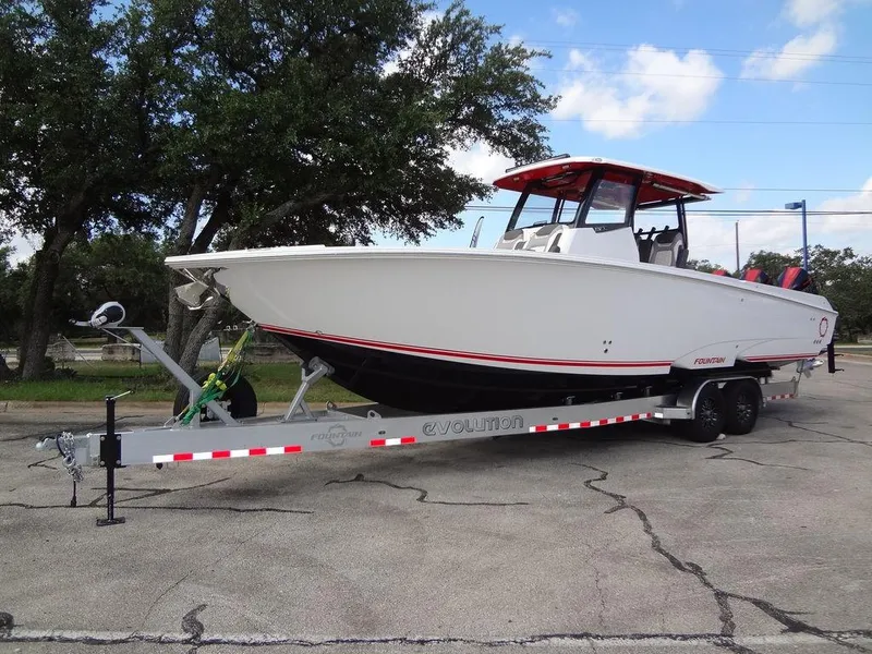 Slide: The Image of 2024 Fountain 32NX boat on a trailer in a parking lot. - 5