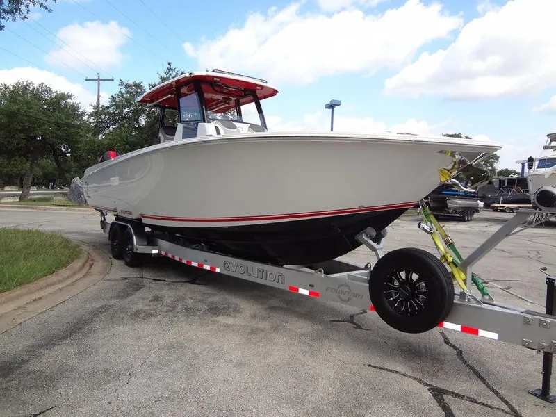 Slide: The Image of 2024 Fountain 32NX boat on a trailer, side view, outdoors. - 6