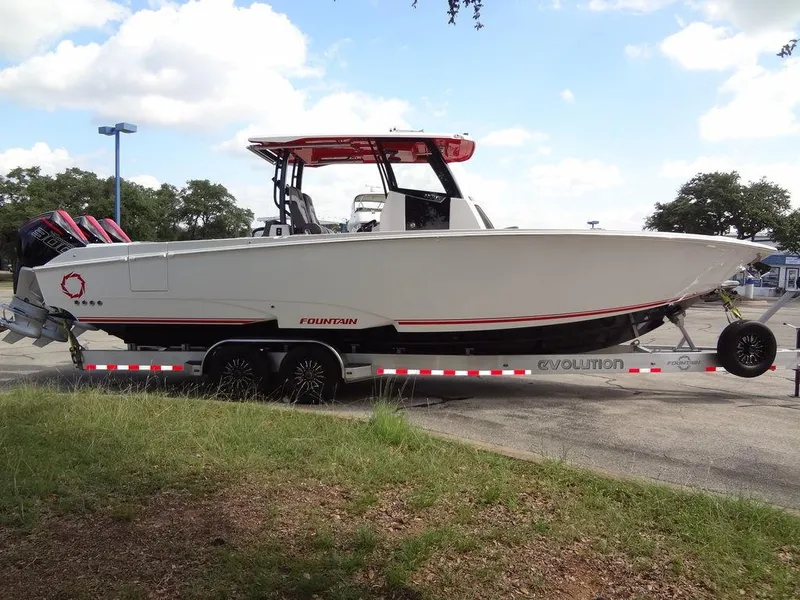 Slide: The Image of 2024 Fountain 32NX boat on a trailer in a parking lot. - 7