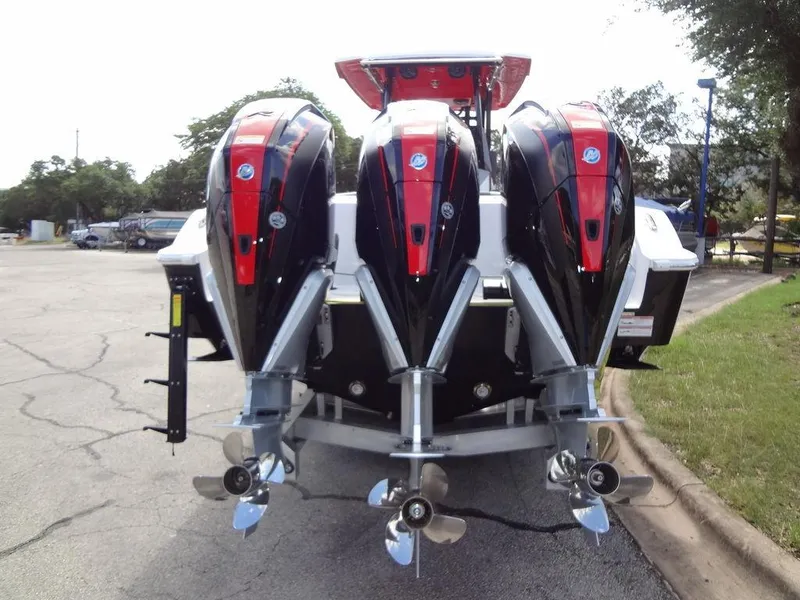 Slide: The Image of 2024 Fountain 32NX boat with triple outboard engines, rear view. - 9