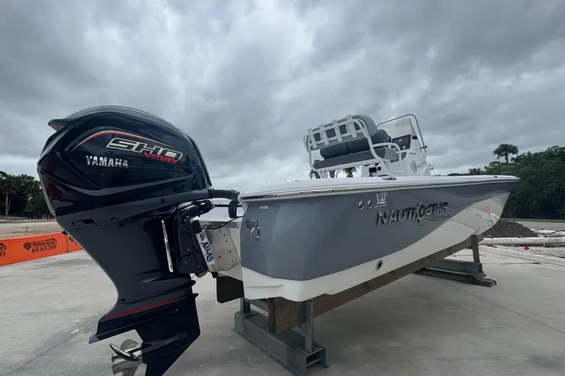 Slide: The Image of 2024 NauticStar 224 Bay boat with Yamaha engine on display outdoors. - 10
