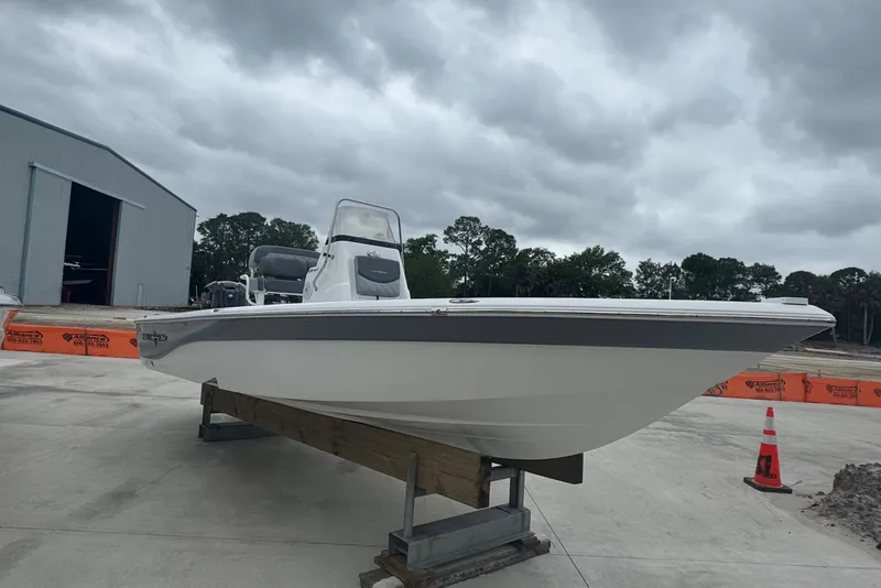 Slide: The Image of 2024 NauticStar 224 Bay boat on display under cloudy skies. - 11
