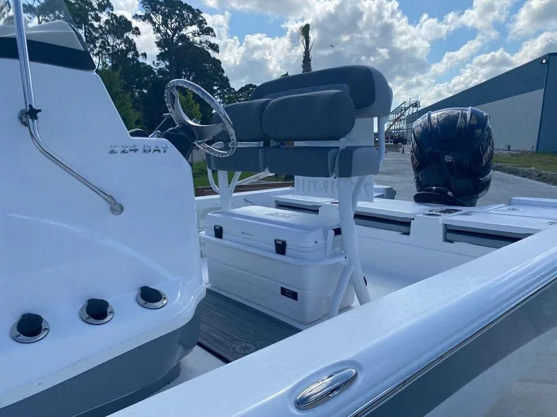 Slide: The Image of 2024 NauticStar 224 Bay boat interior with seating and console. - 5