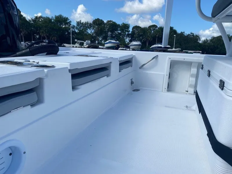 Slide: The Image of 2024 NauticStar 224 Bay boat interior with storage compartments and seating. - 7